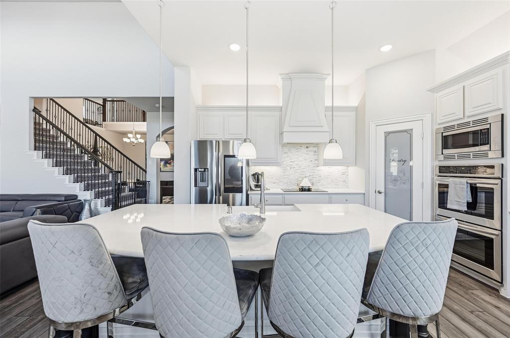 609 Dusty Glen Trail Midlothian, TX 76065 - Photo 3 of 40 a large kitchen with a table and chairs