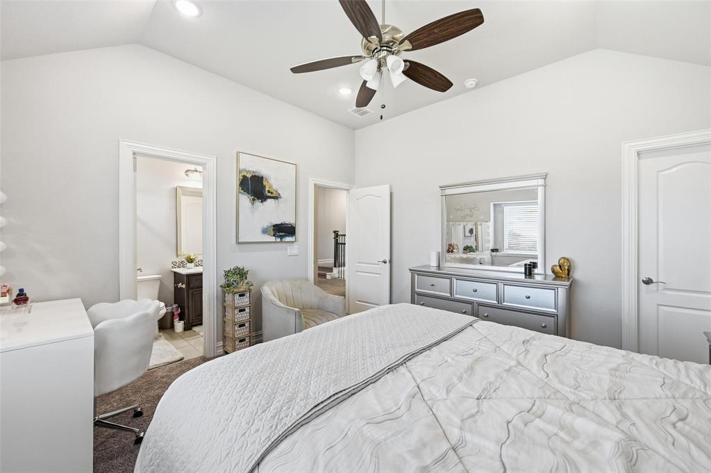 609 Dusty Glen Trail Midlothian, TX 76065 - Photo 31 of 40 a bedroom with a bed and a chandelier