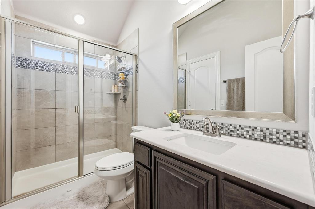 609 Dusty Glen Trail Midlothian, TX 76065 - Photo 32 of 40 a bathroom with a sink a toilet and shower