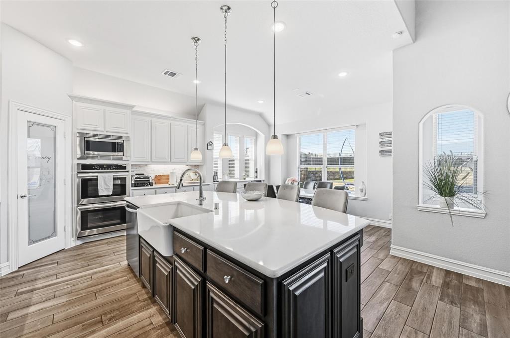 609 Dusty Glen Trail Midlothian, TX 76065 - Photo 9 of 40 a large kitchen with kitchen island a large counter top appliances and cabinets