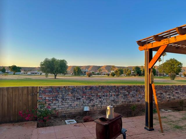 1395 Lause Road Bullhead City, AZ 86442 - Photo 25 of 34 Outdoor patio featuring a wooden pergola, brick privacy wall, and wood-paneled gate