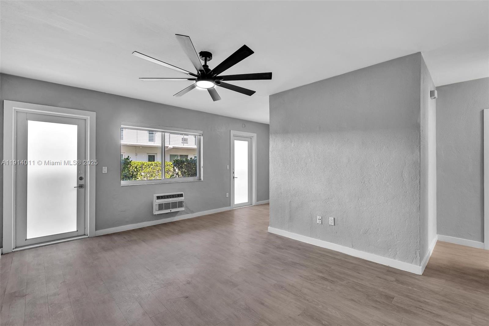 9200 East Bay Harbor Drive, Unit 2A Bay Harbor Islands, FL 33154 - Photo 11 of 45 a view of a livingroom with a ceiling fan and window