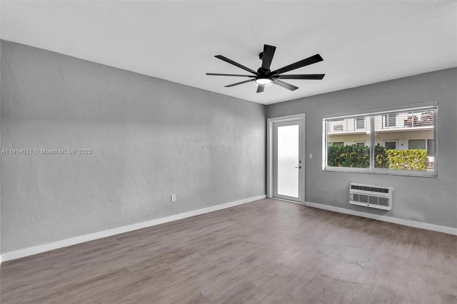 9200 East Bay Harbor Drive, Unit 2A Bay Harbor Islands, FL 33154 - Photo 13 of 45 an empty room with windows and ceiling fan