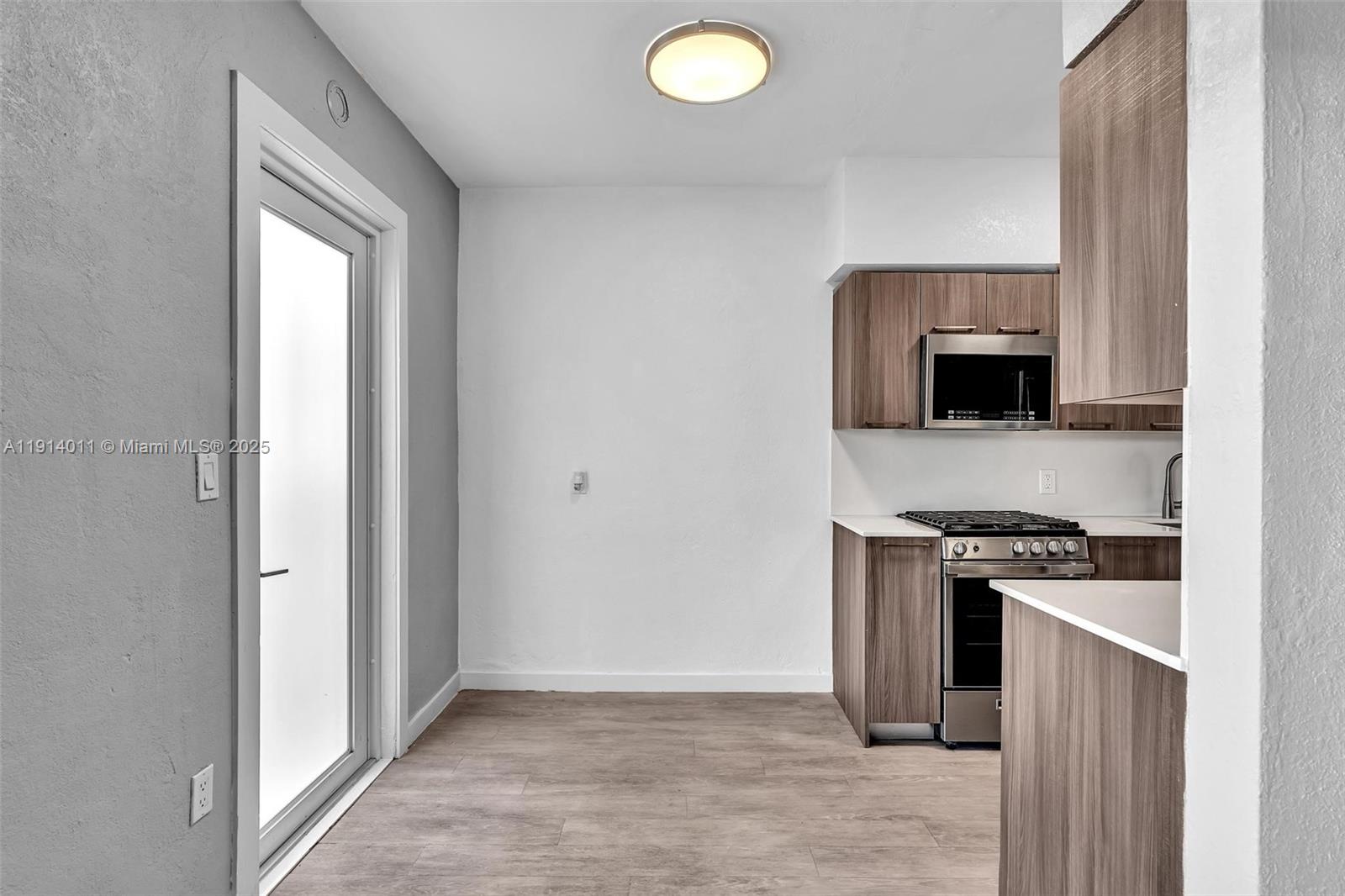 9200 East Bay Harbor Drive, Unit 2A Bay Harbor Islands, FL 33154 - Photo 14 of 45 a kitchen with a stove and a microwave