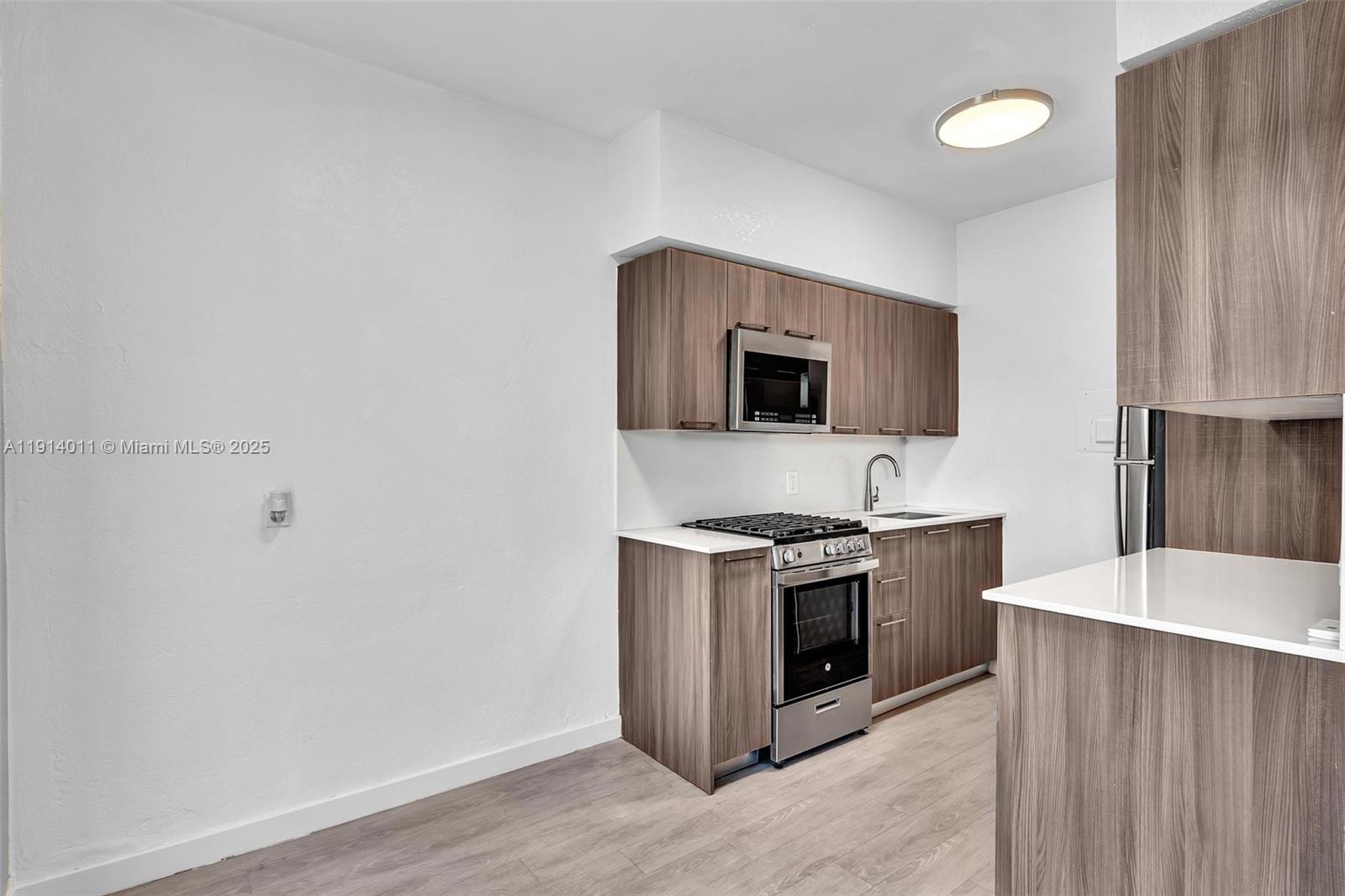 9200 East Bay Harbor Drive, Unit 2A Bay Harbor Islands, FL 33154 - Photo 15 of 45 a kitchen with a stove and a microwave