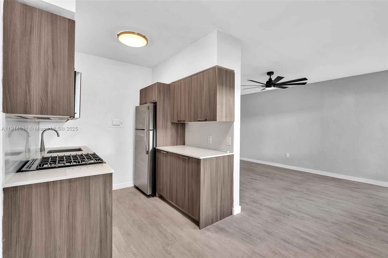 9200 East Bay Harbor Drive, Unit 2A Bay Harbor Islands, FL 33154 - Photo 16 of 45 a kitchen with stainless steel appliances a sink cabinets and wooden floor