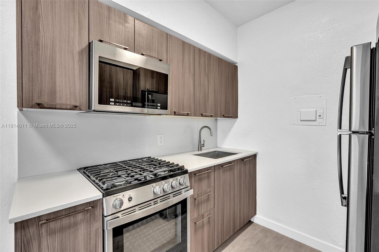 9200 East Bay Harbor Drive, Unit 2A Bay Harbor Islands, FL 33154 - Photo 19 of 45 a kitchen with a stove and a microwave