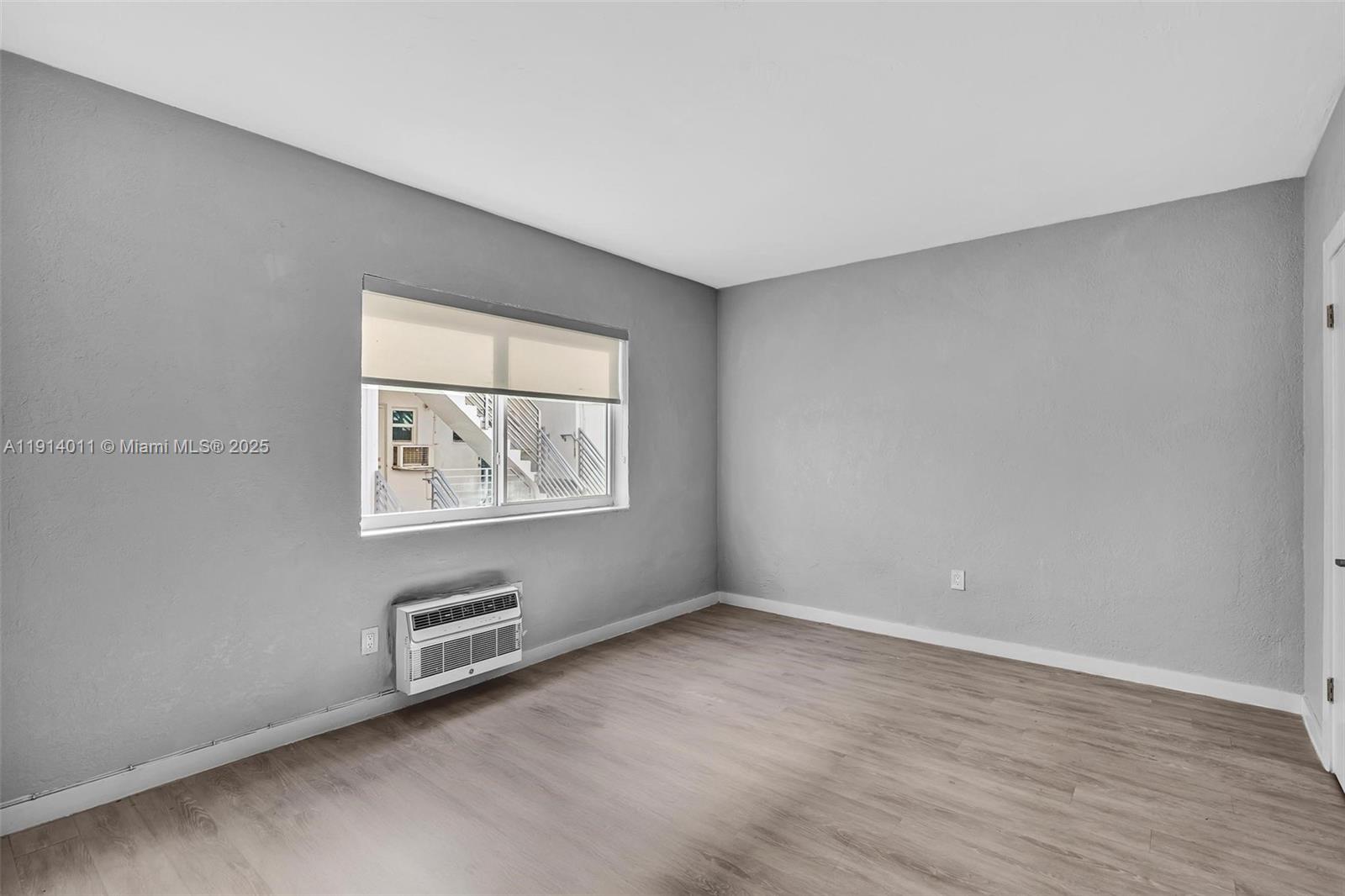 9200 East Bay Harbor Drive, Unit 2A Bay Harbor Islands, FL 33154 - Photo 20 of 45 wooden floor in an empty room with a window