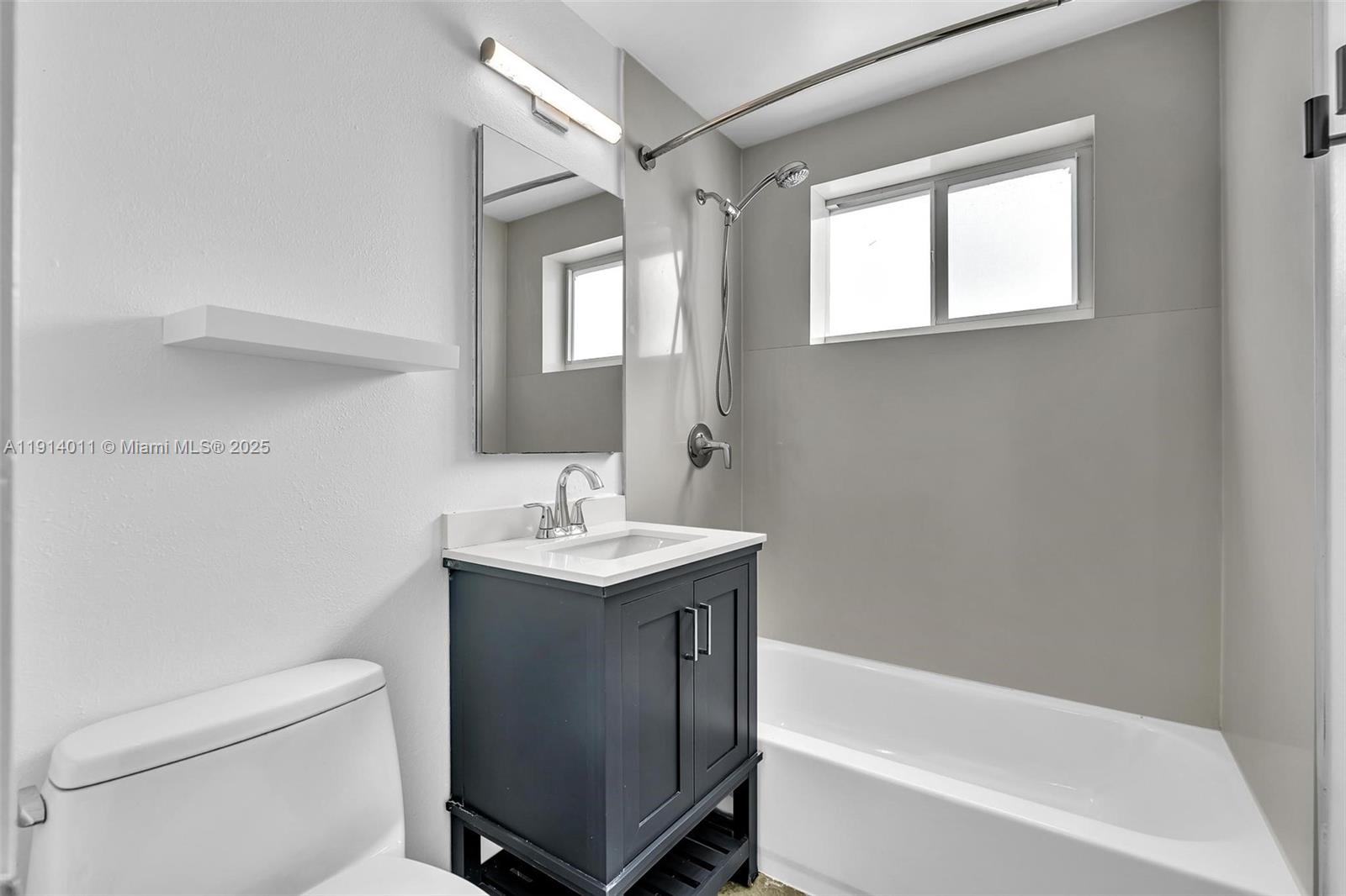 9200 East Bay Harbor Drive, Unit 2A Bay Harbor Islands, FL 33154 - Photo 25 of 45 a bathroom with a sink a toilet and shower