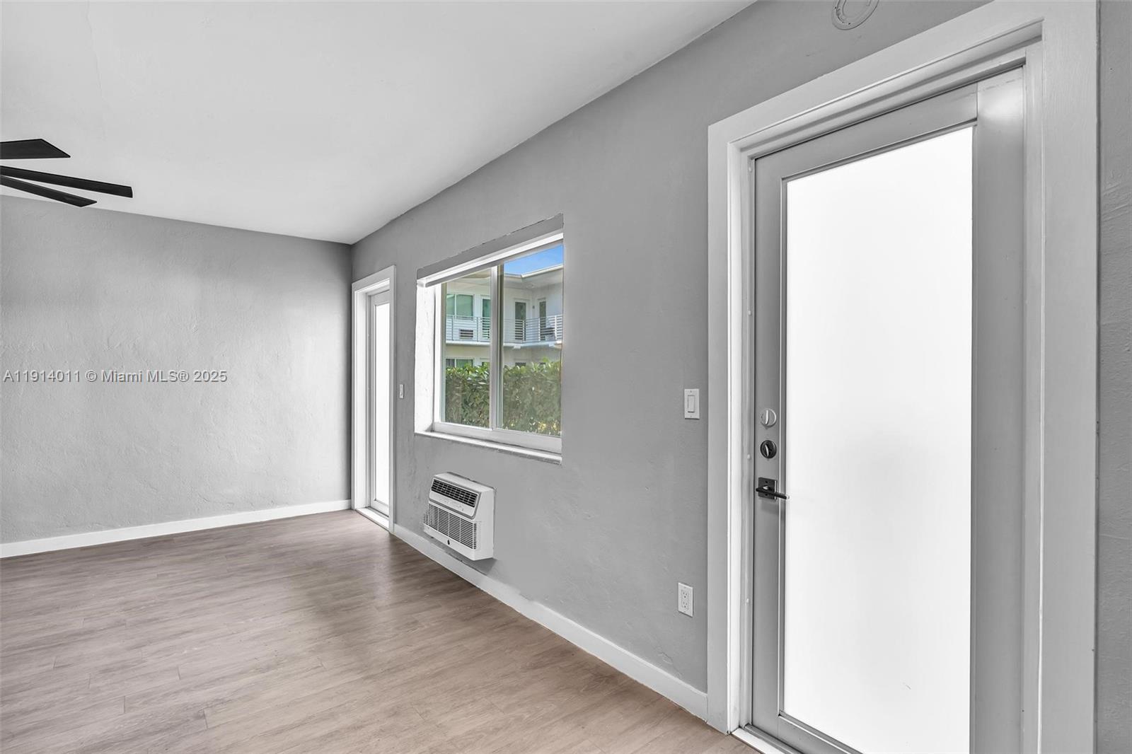9200 East Bay Harbor Drive, Unit 2A Bay Harbor Islands, FL 33154 - Photo 28 of 45 a view of an empty room with a window and wooden floor