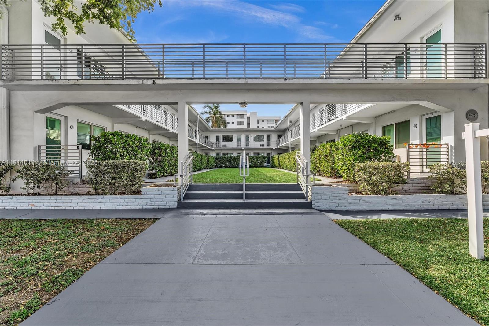 9200 East Bay Harbor Drive, Unit 2A Bay Harbor Islands, FL 33154 - Photo 36 of 45 a view of house with a big yard potted plants and a table and chairs