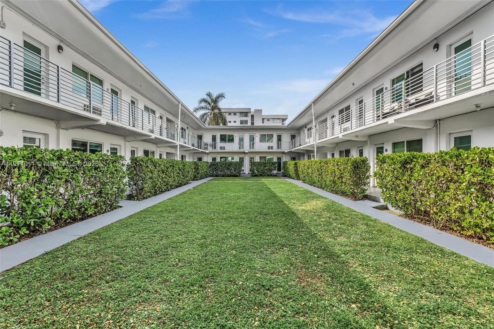 9200 East Bay Harbor Drive, Unit 2A Bay Harbor Islands, FL 33154 - Photo 37 of 45 a view of building with a yard