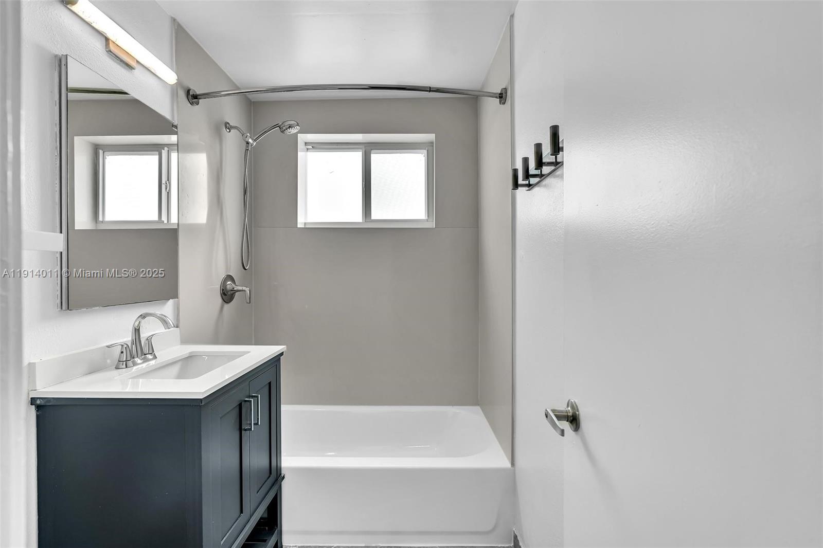 9200 East Bay Harbor Drive, Unit 2A Bay Harbor Islands, FL 33154 - Photo 4 of 45 a bathroom with a bathtub a sink and mirror