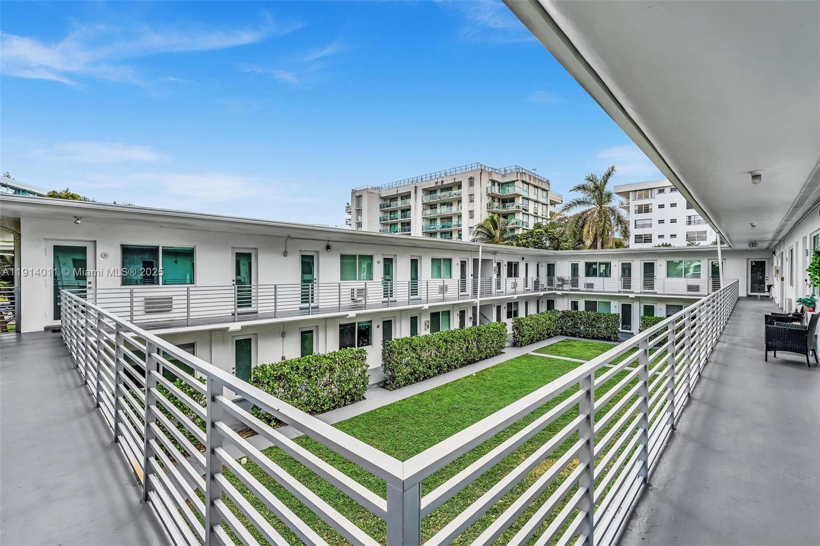 9200 East Bay Harbor Drive, Unit 2A Bay Harbor Islands, FL 33154 - Photo 43 of 45 a view of balcony with two chairs and wooden fence