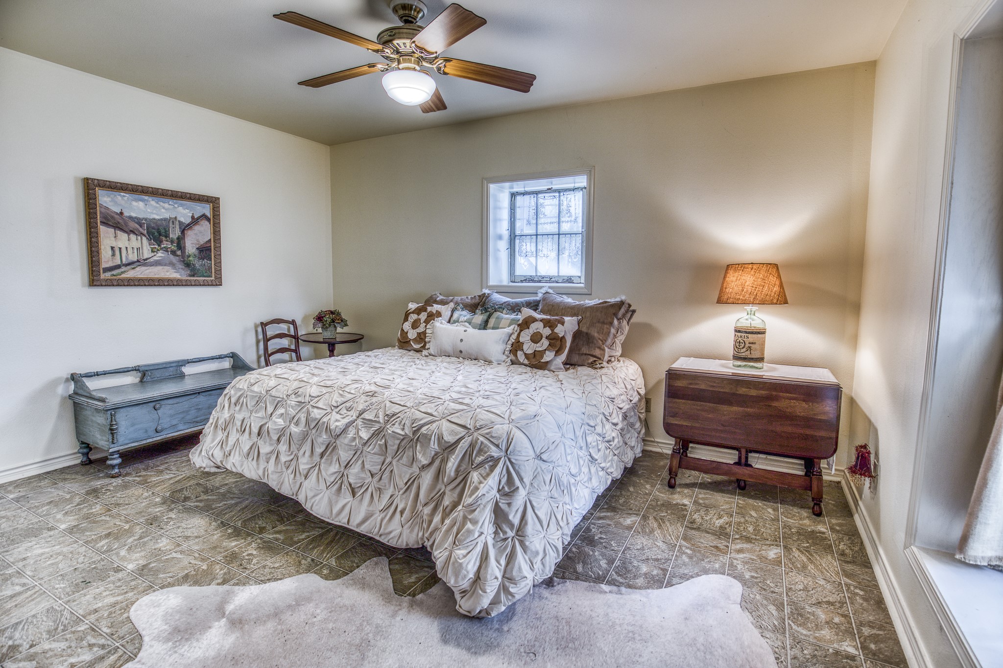 533 Bybee Road Round Top, TX 78954 - Photo 11 of 29 a bedroom with a bed and a chandelier
