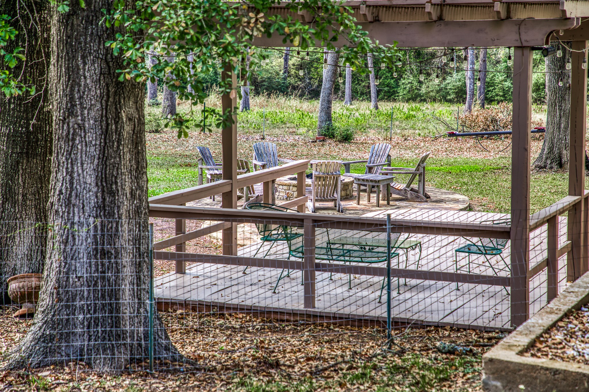 533 Bybee Road Round Top, TX 78954 - Photo 21 of 29 a view of a wooden balcony with chairs