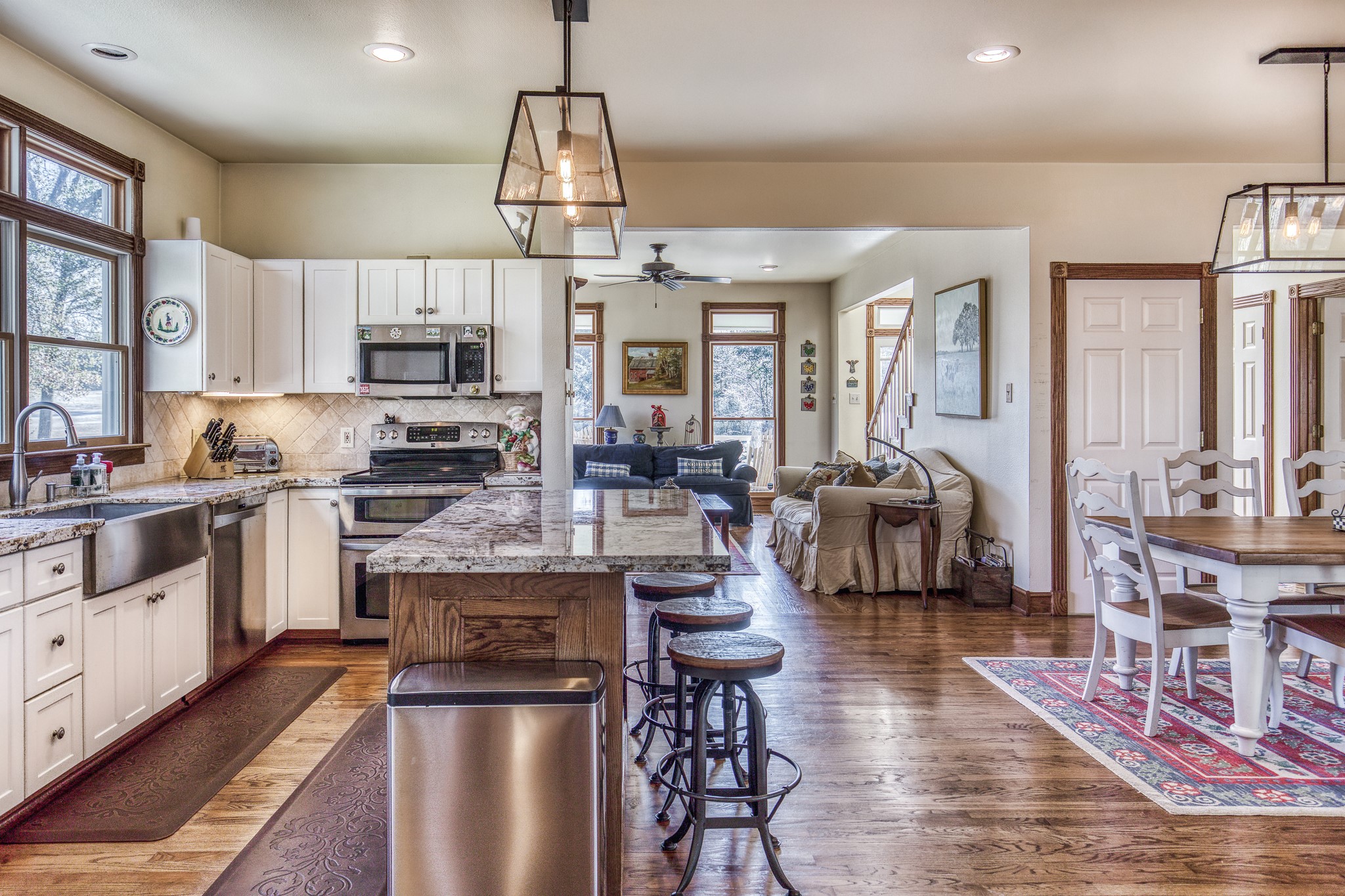 533 Bybee Road Round Top, TX 78954 - Photo 3 of 29 a kitchen with kitchen island granite countertop a stove top oven a sink a dining table and chairs