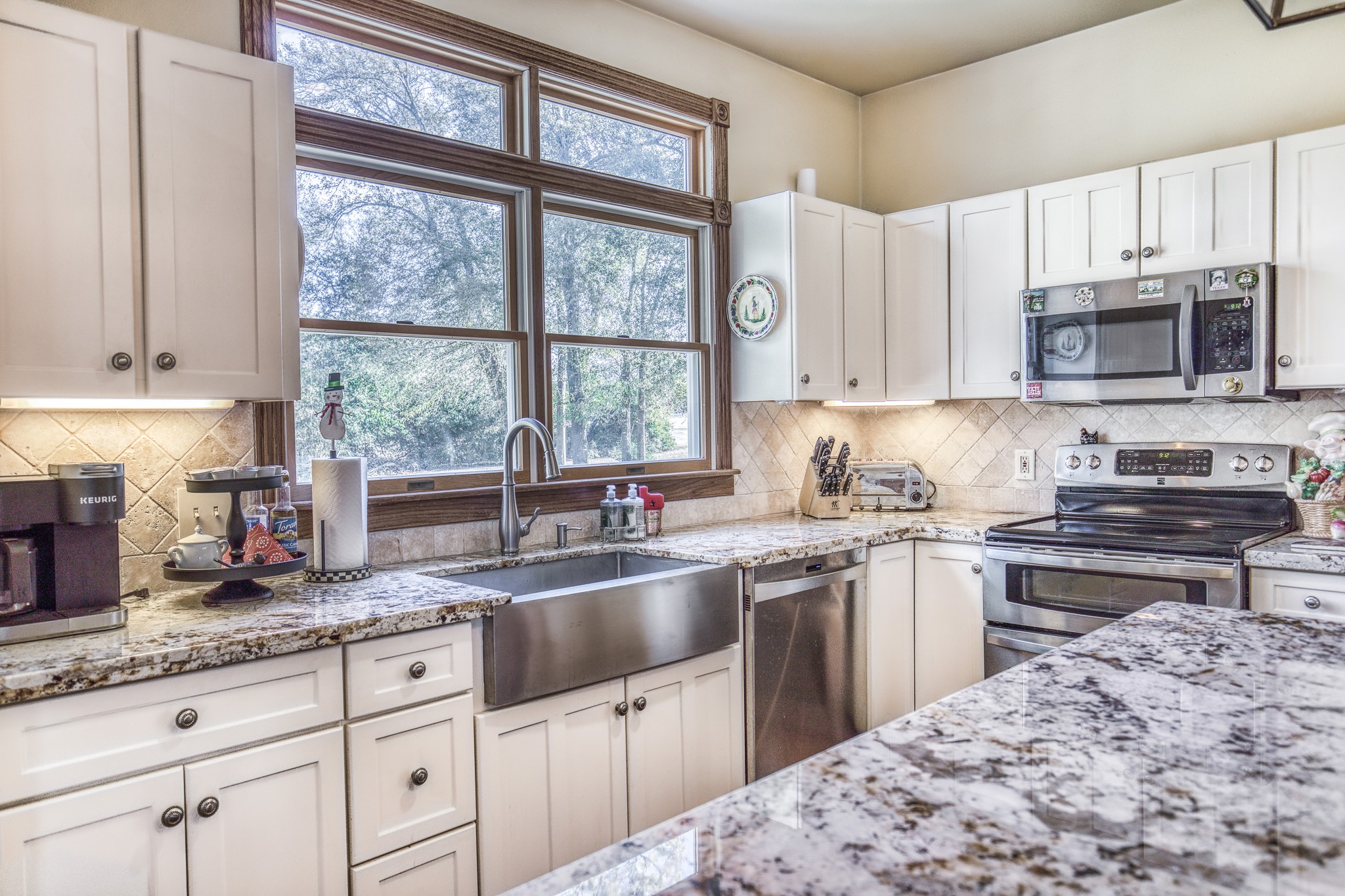 533 Bybee Road Round Top, TX 78954 - Photo 5 of 29 a kitchen with granite countertop a sink window and cabinets