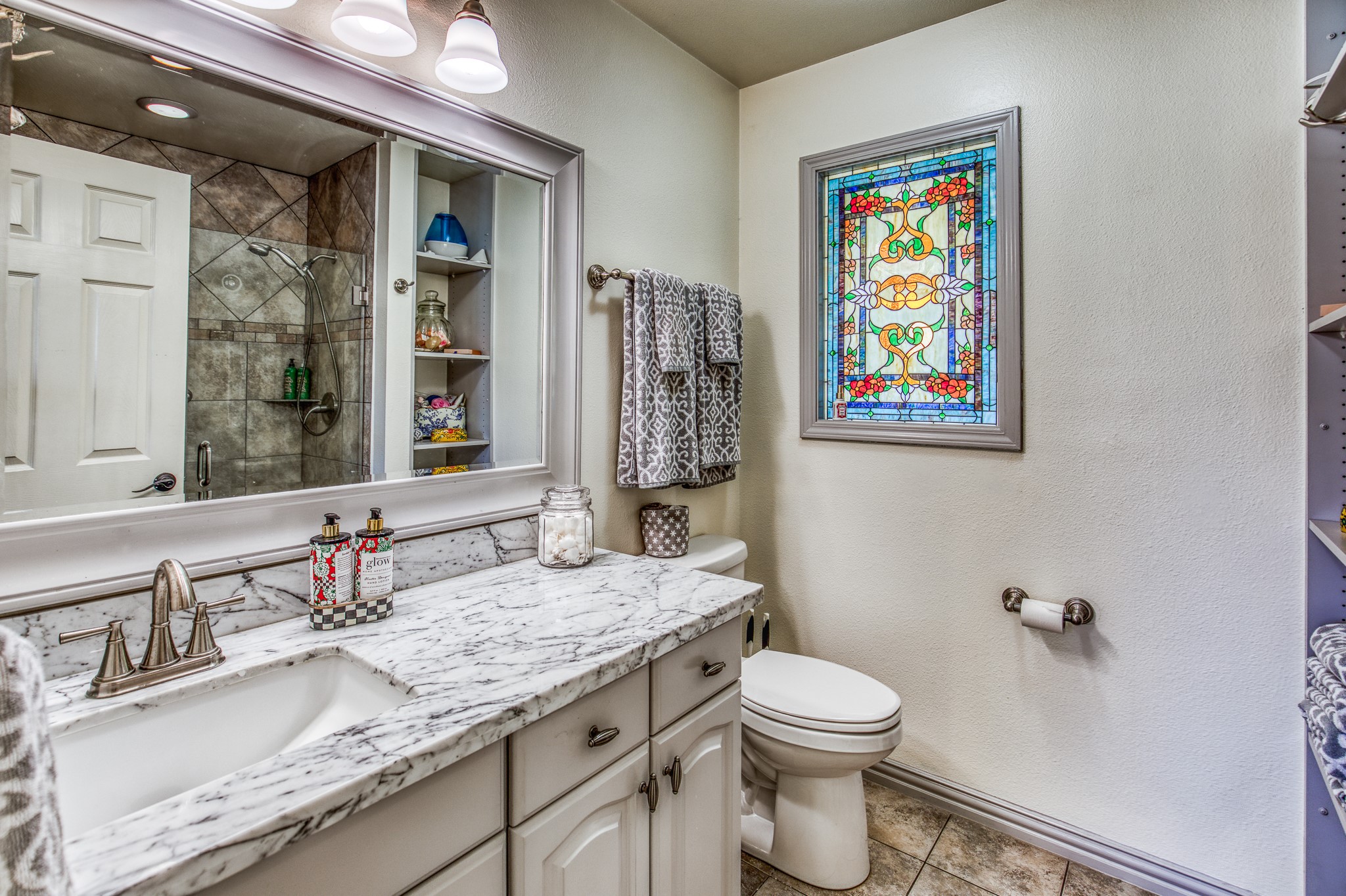 533 Bybee Road Round Top, TX 78954 - Photo 10 of 29 a bathroom with a granite countertop toilet sink and mirror