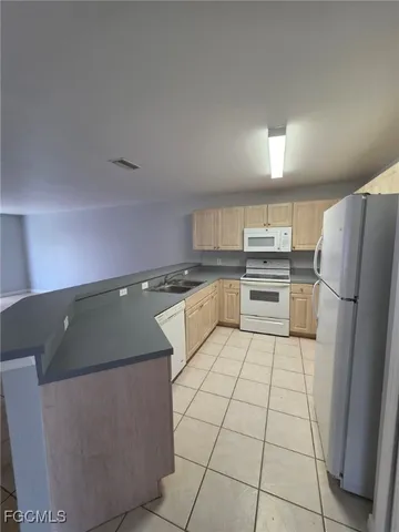 a kitchen with stainless steel appliances granite countertop a refrigerator sink and cabinets