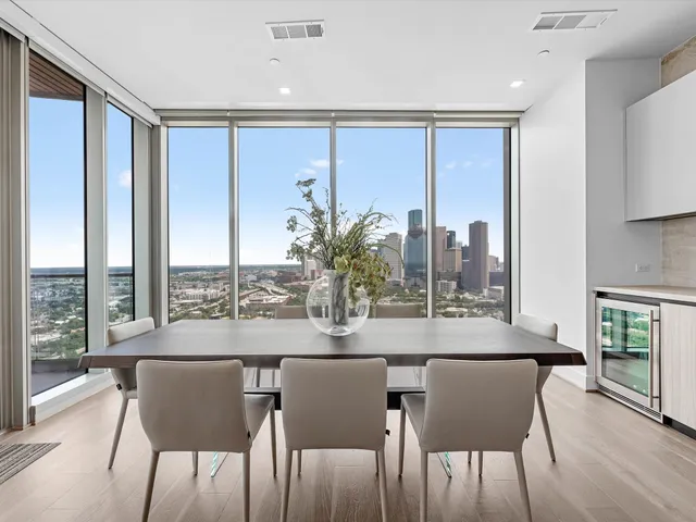a dining room with furniture and wooden floor