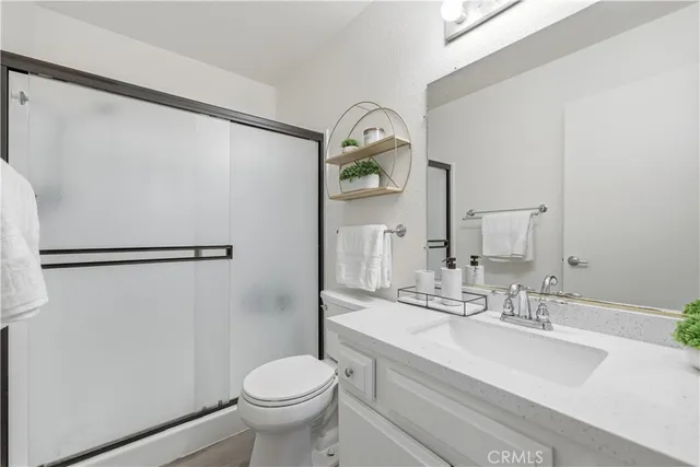 a bathroom with a sink toilet and a mirror