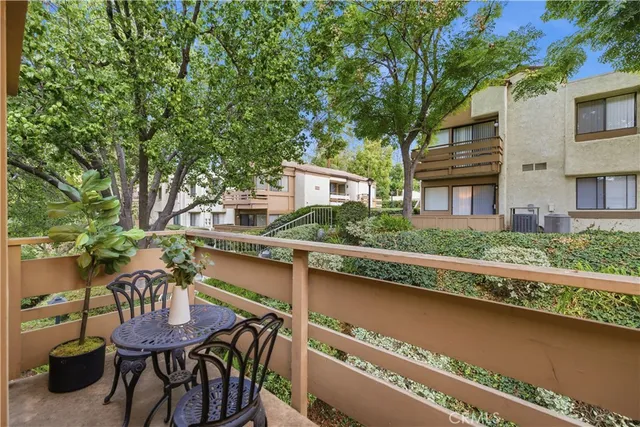 a view of a chairs and table in patio