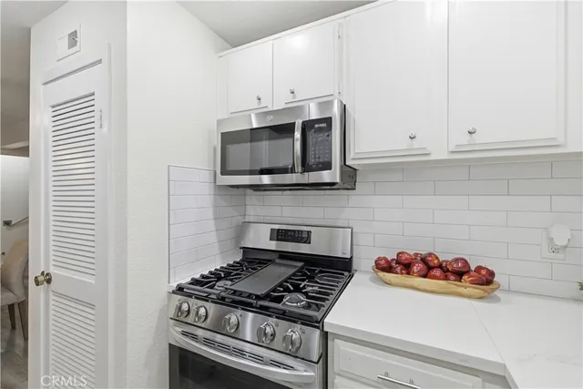 a kitchen with a stove and a microwave