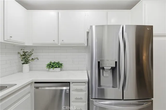 a kitchen with a refrigerator and cabinets