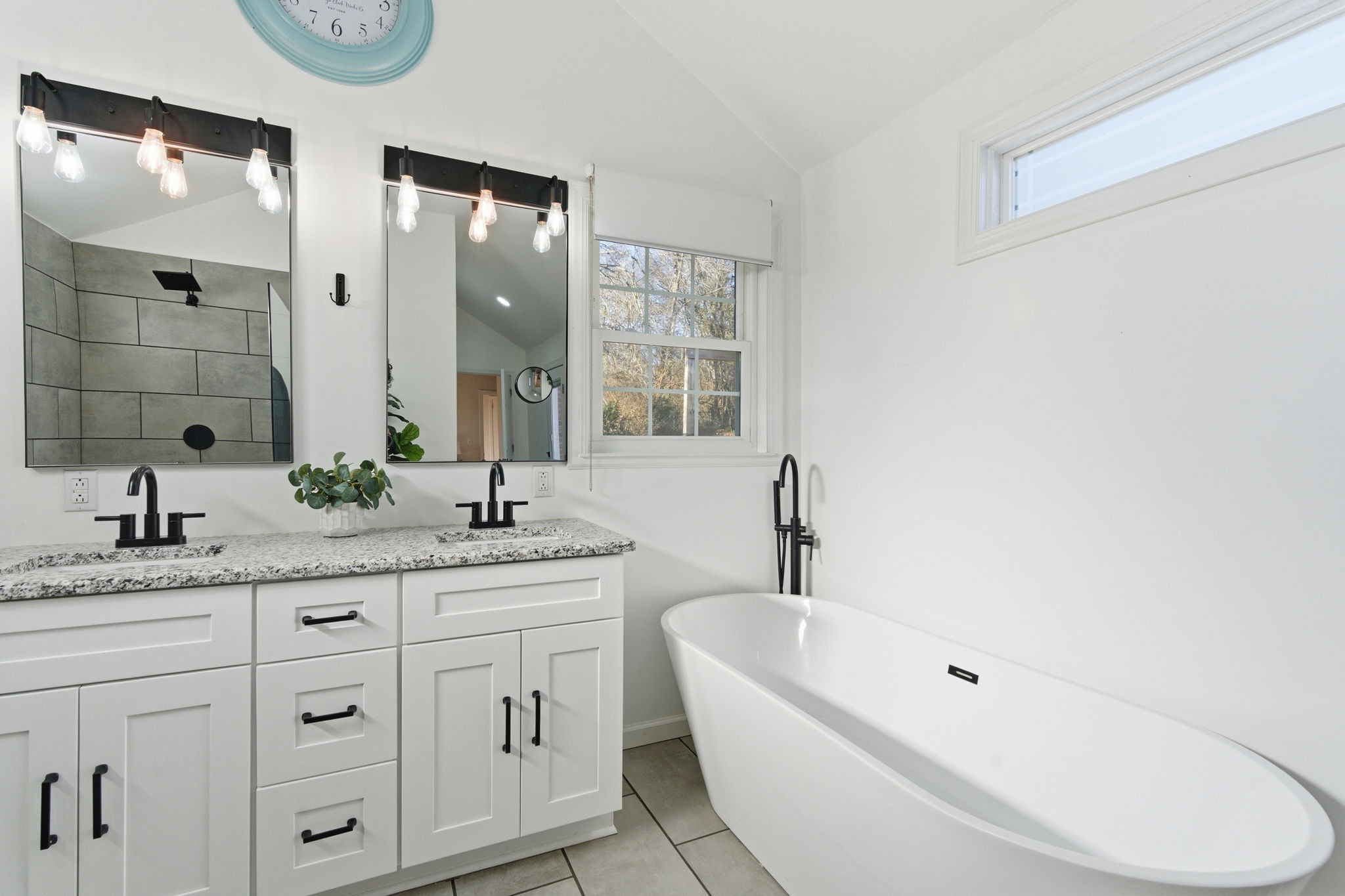 434 Adair Road Nashville, TN 37214 - Photo 20 of 25 a bathroom with a granite countertop sink double vanity mirror bathtub and next to a window