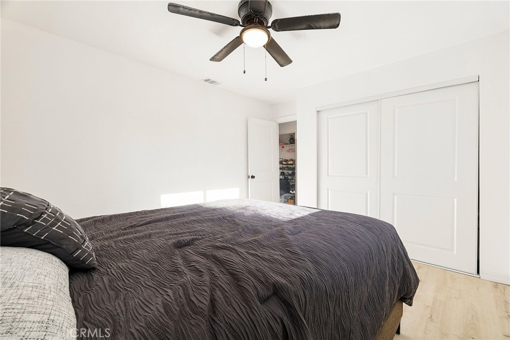 342 Rio Vista Court Corning, CA 96021 - Photo 13 of 28 a view of a bedroom with a bed and a chandelier fan
