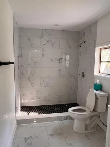 a white toilet sitting next to a bathroom sink