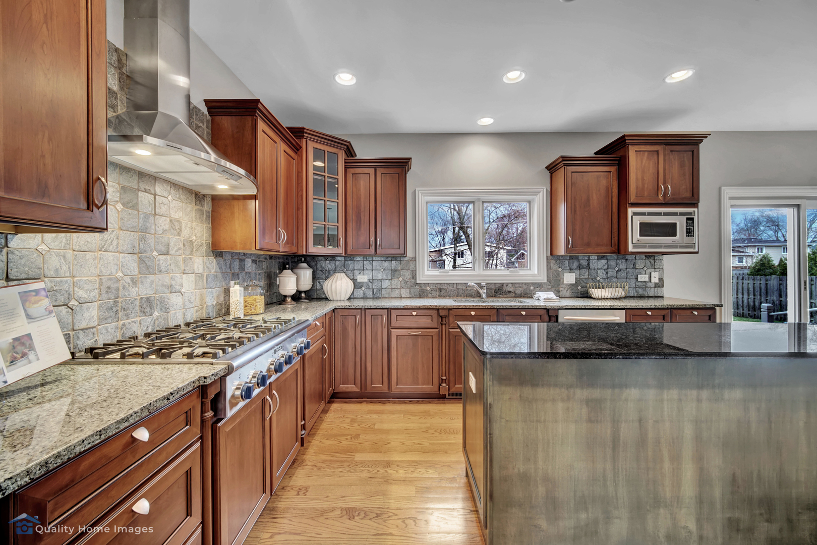 1323 Kenton Road Deerfield, IL 60015 - Photo 3 of 20 a kitchen with stainless steel appliances granite countertop a stove a sink dishwasher and a microwave oven with large cabinets