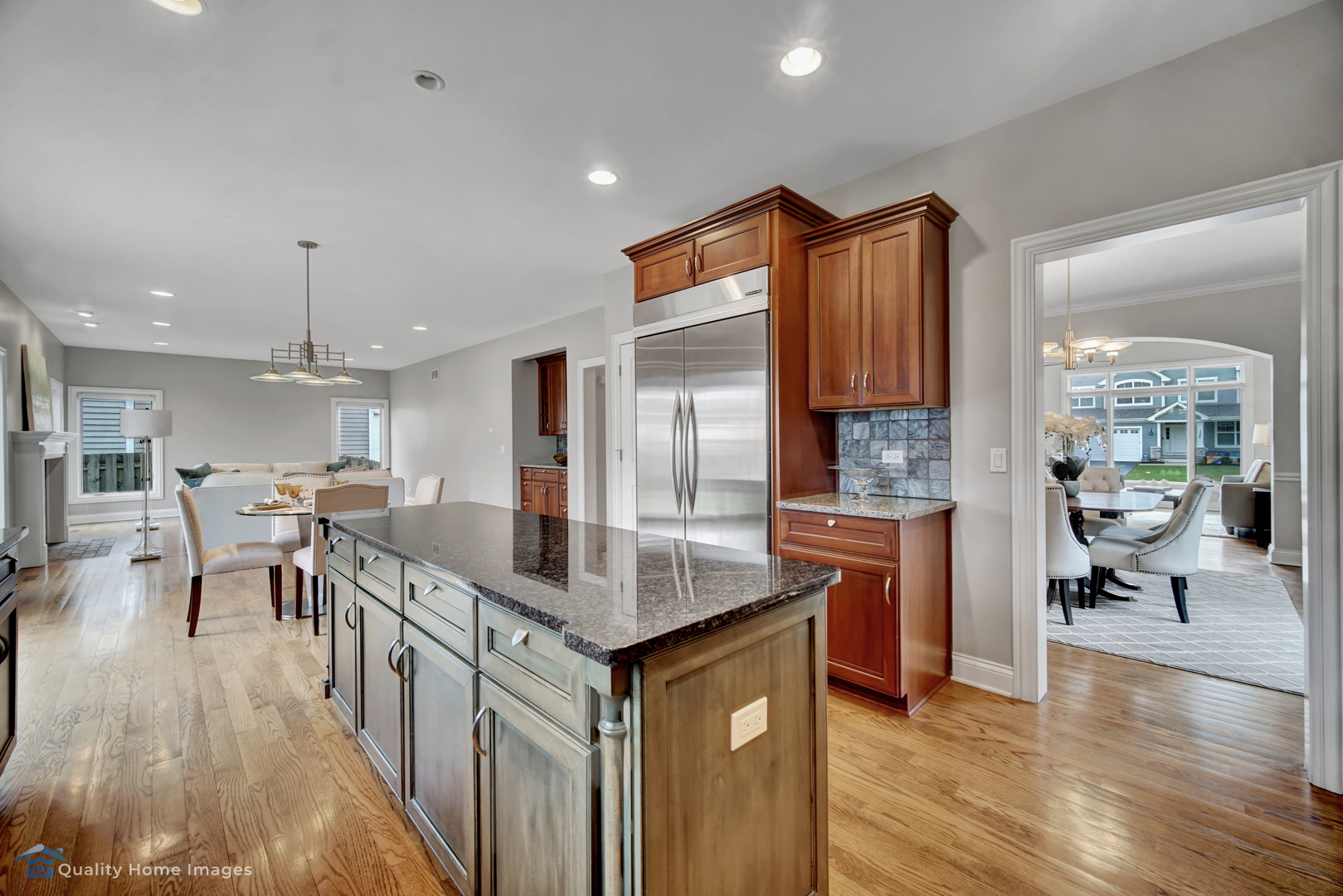 1323 Kenton Road Deerfield, IL 60015 - Photo 4 of 20 a kitchen with stainless steel appliances granite countertop a kitchen island a stove a sink a dining table and chairs