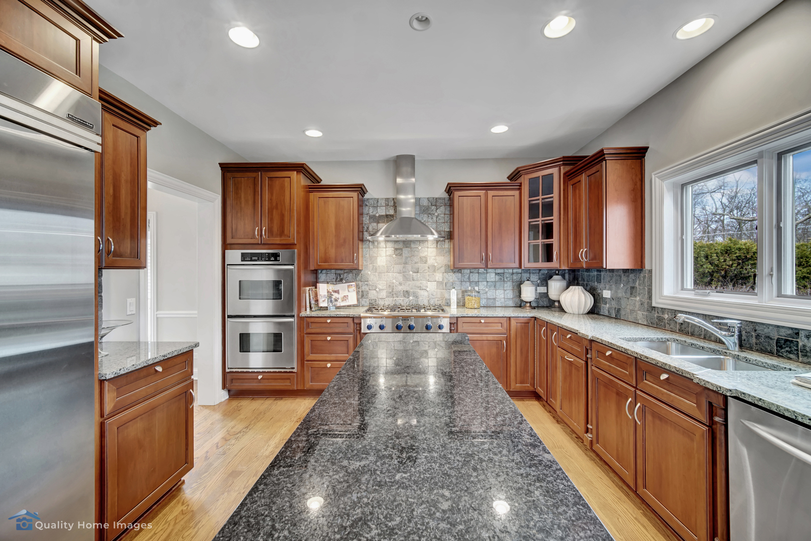 1323 Kenton Road Deerfield, IL 60015 - Photo 5 of 20 a large kitchen with stainless steel appliances kitchen island granite countertop a large counter top stainless steel appliances and cabinets