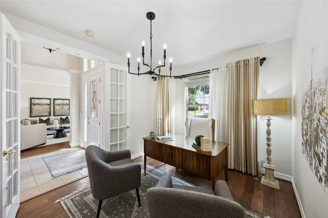 a living room with furniture and a chandelier