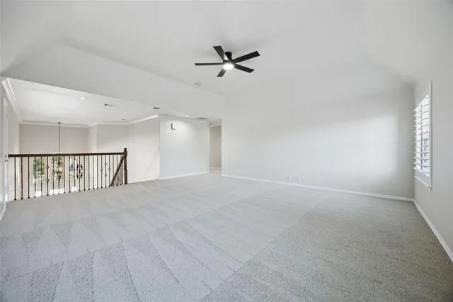a view of a livingroom with a ceiling fan and window