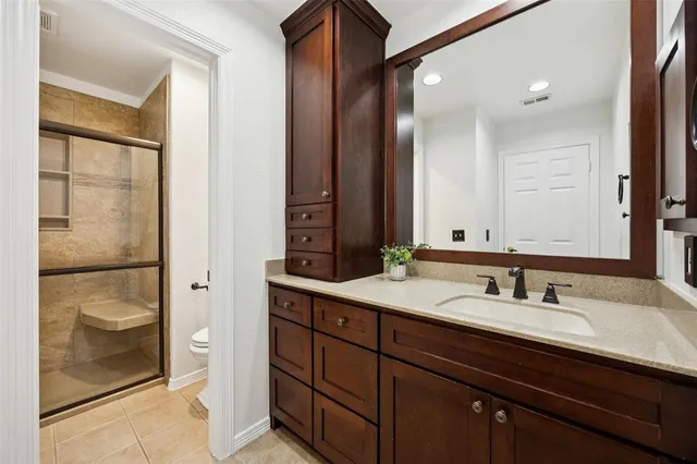 a bathroom with a sink double vanity and a shower