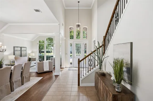 a living room with furniture a flat screen tv and a potted plant