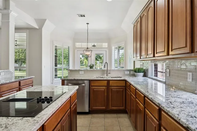 a kitchen with stainless steel appliances granite countertop a sink stove and cabinets