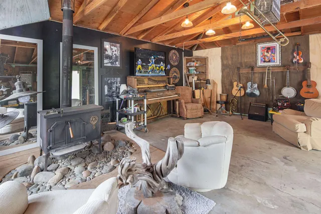 a room with lots of white furniture and chandelier