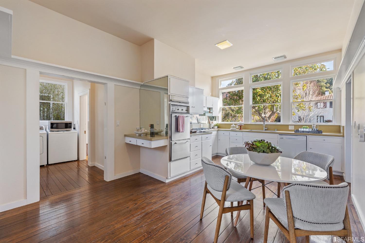 2967 Avalon Avenue Berkeley, CA 94705 - Photo 24 of 77 a kitchen with a table chairs refrigerator and cabinets