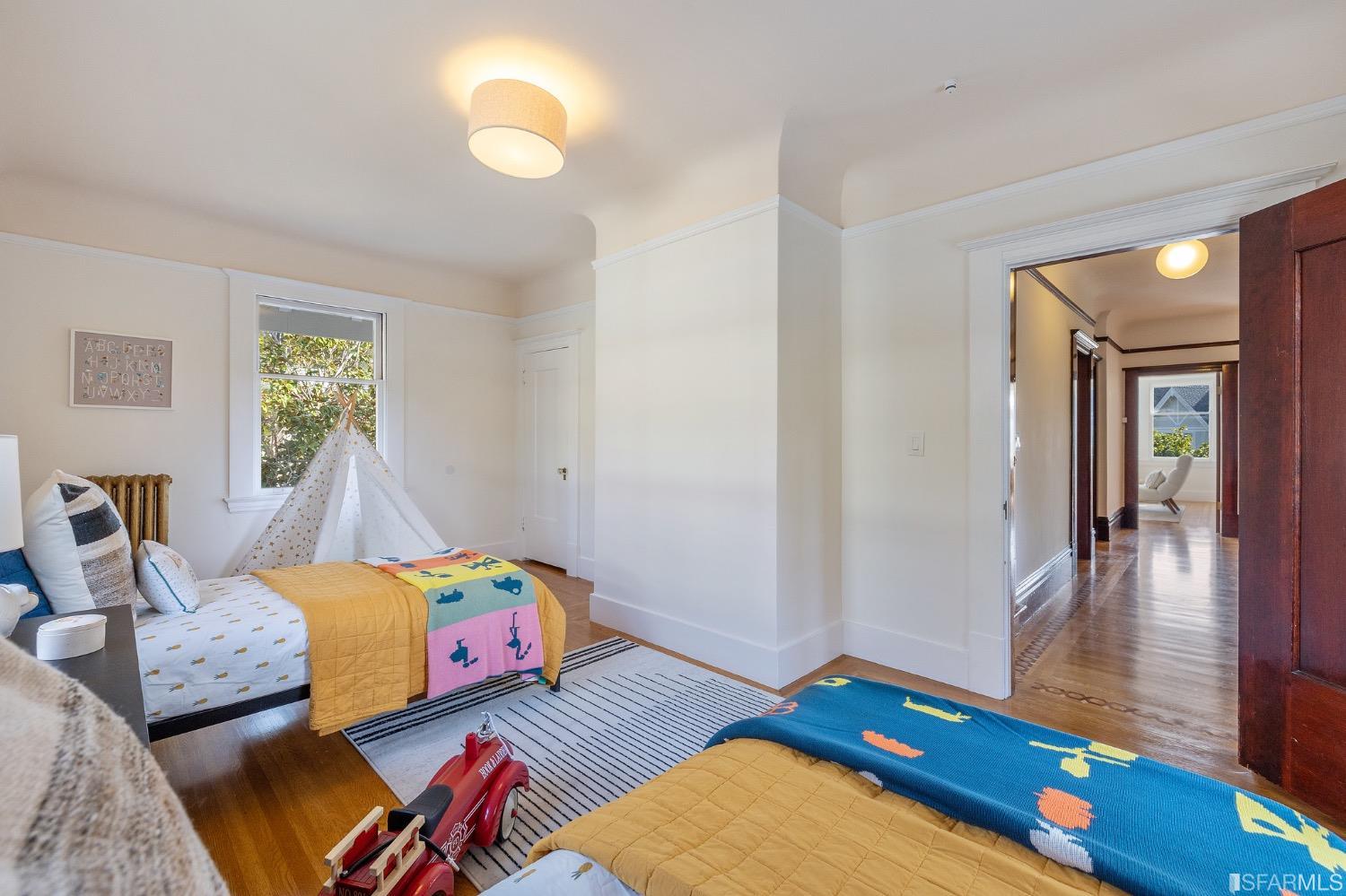 2967 Avalon Avenue Berkeley, CA 94705 - Photo 48 of 77 a bedroom with a bed and wooden floor