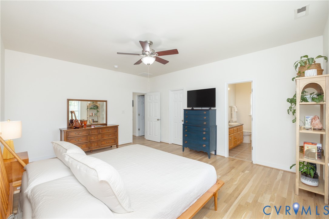 15618 Rowlett Road Chesterfield, VA 23838 - Photo 6 of 29 a bedroom with a bed and a flat screen tv
