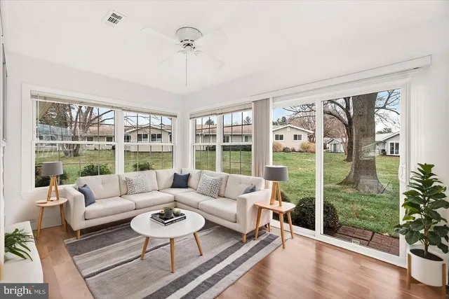 a living room with furniture and a floor to ceiling window