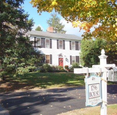 46 Interlaken Road Stockbridge, MA 01262 - Photo 2 of 35 a front view of a house with a garden and tree