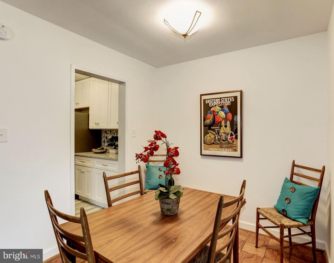 2400 41st Street Northwest, Unit 203 Washington, DC 20007 - Photo 4 of 24 a dining room with furniture and wooden floor