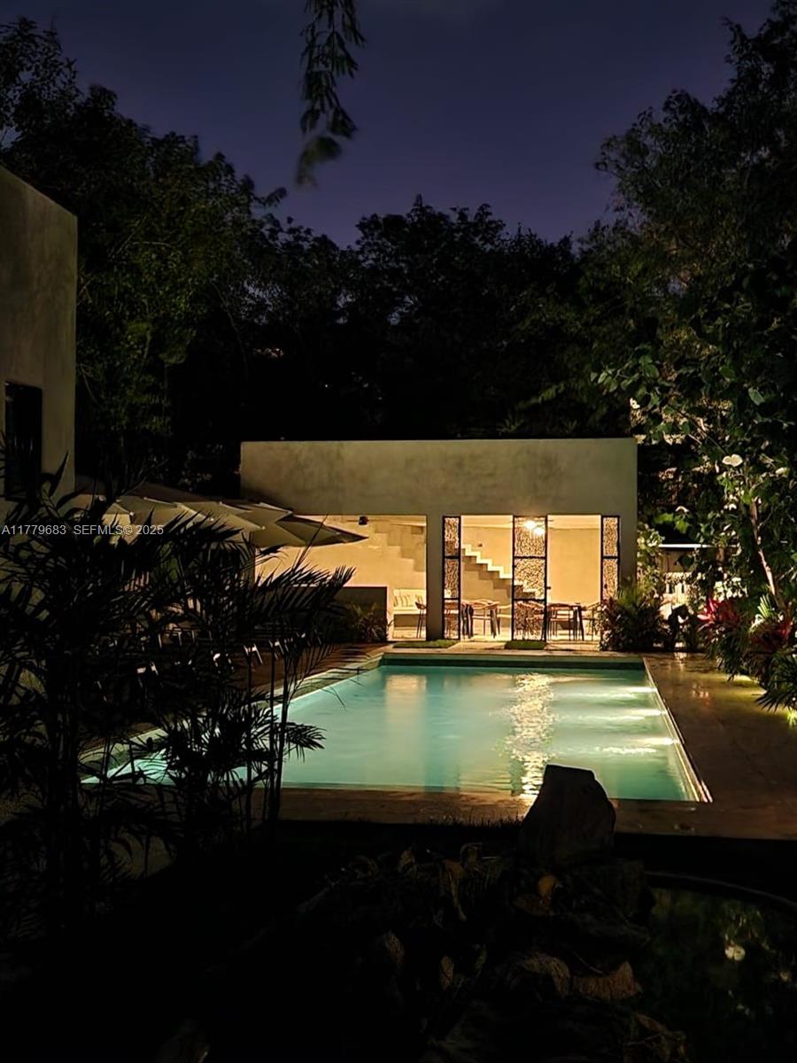 77760 Itzamna, Unit D101 undefined, FL 00000 - Photo 15 of 35 a view of a swimming pool with an outdoor space and seating area