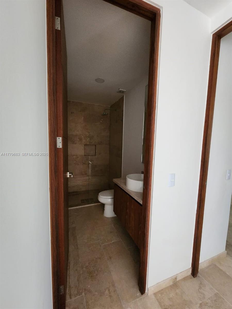 77760 Itzamna, Unit D101 undefined, FL 00000 - Photo 18 of 35 a bathroom with a toilet and a shower