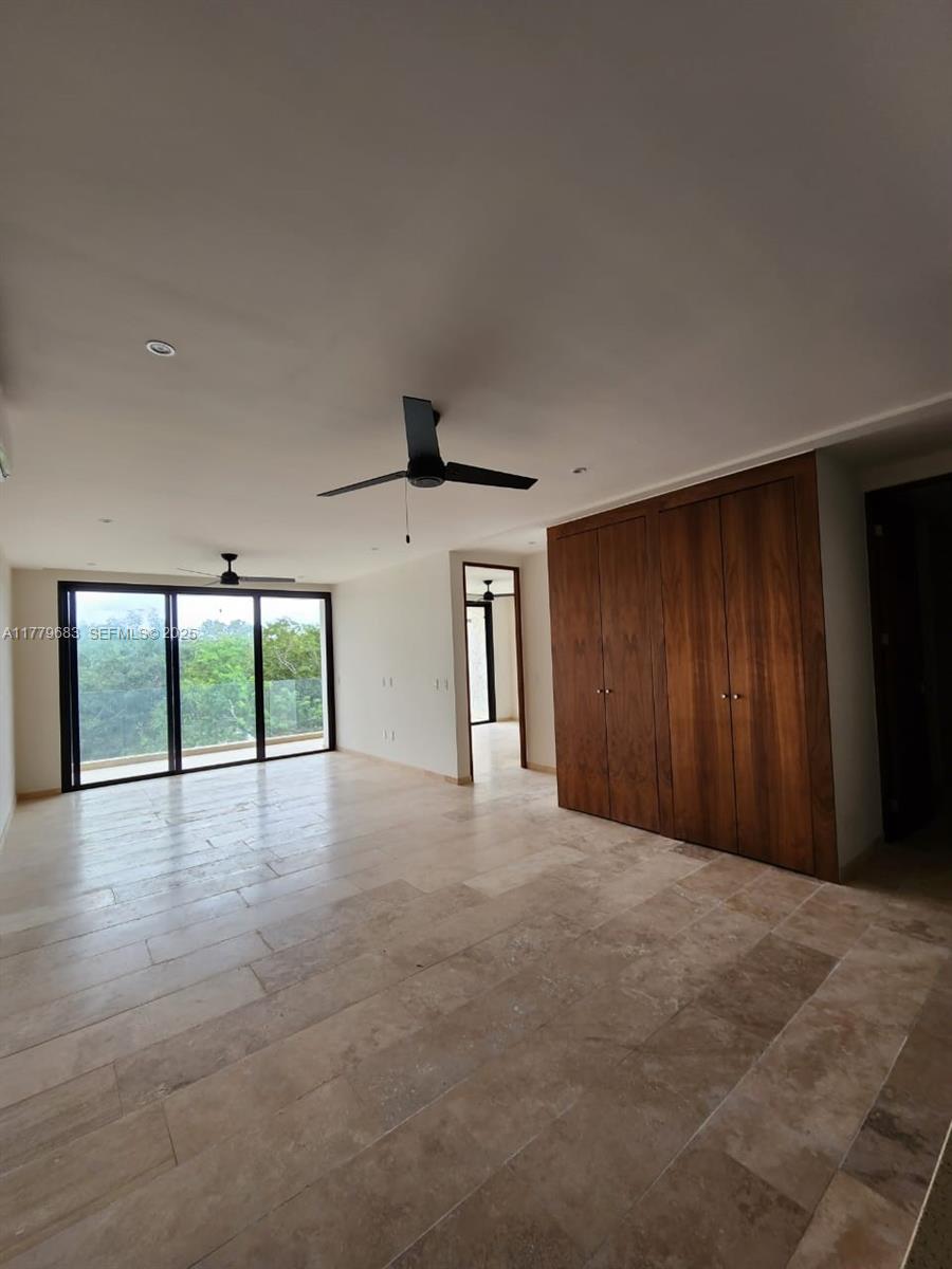 77760 Itzamna, Unit D101 undefined, FL 00000 - Photo 24 of 35 a view of an empty room with a window and wooden floor